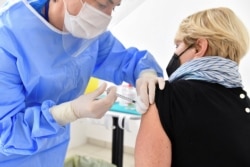 A medical worker administers the Russian Sputnik V coronavirus vaccine in the Republic of San Marino, March 29, 2021.