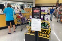 FILE - A sign at a pharmacy informs customers the Pfizer COVID-19 vaccine is in stock, in a grocery store in Cape May Court House, New Jersey, July 19, 2021.