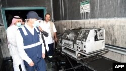 Saudi officials inspect damage inside the Jazan General Hospital after a blaze broke out in the intensive care unit and maternity department, Dec. 24, 2015, in Saudi Arabia's southern Jizan province.