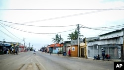 A lone man crosses the empty streets of Maputo, Mozambique, Oct. 21, 2024, during a nationwide shutdown protest following a disputed Oct. 9 election.