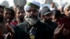 Supporters of the Tehreek-e-Labbaik Pakistan Islamist political party say a prayer after their leader Khadim Hussain Rizvi announced an end to their protest in Islamabad, Pakistan, Nov. 27, 2017. The party has called off new protests following an agreement with the government.