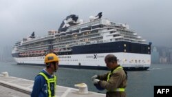 (FILES) In this file photo taken on March 15, 2013 workers prepare for the arrival of the 'Celebrity Millennium' ship, a Maltese registerd vessel at the under-construction Kai Tak Cruise Terminal in Hong Kong.