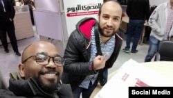 Egyptian journalist Haisam Hasan Mahgoub, left, is seen with a colleague at the offices of Al Masry Al Youm newspaper in a photo posted Jan. 9, 2020, on Mahgoub's Facebook page.