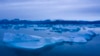 FILE - A boat navigates next to large icebergs near the town of Kulusuk, in eastern Greenland, Aug. 15, 2019. 