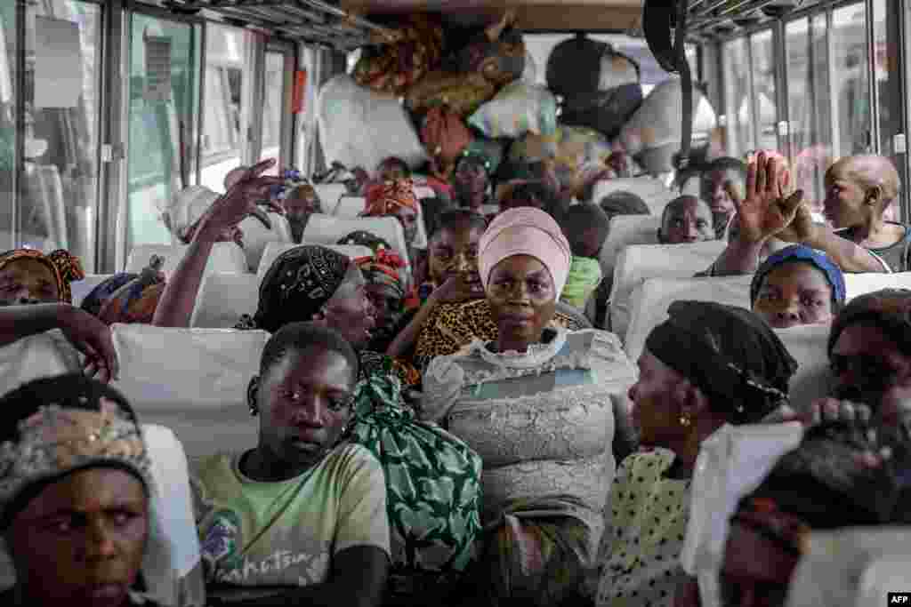 Displaced people who fled Goma, Democratic Republic of the Congo, after the eruption of the Nyiragongo volcano sit on a bus in Sake with their belongings, waiting to be taken home.