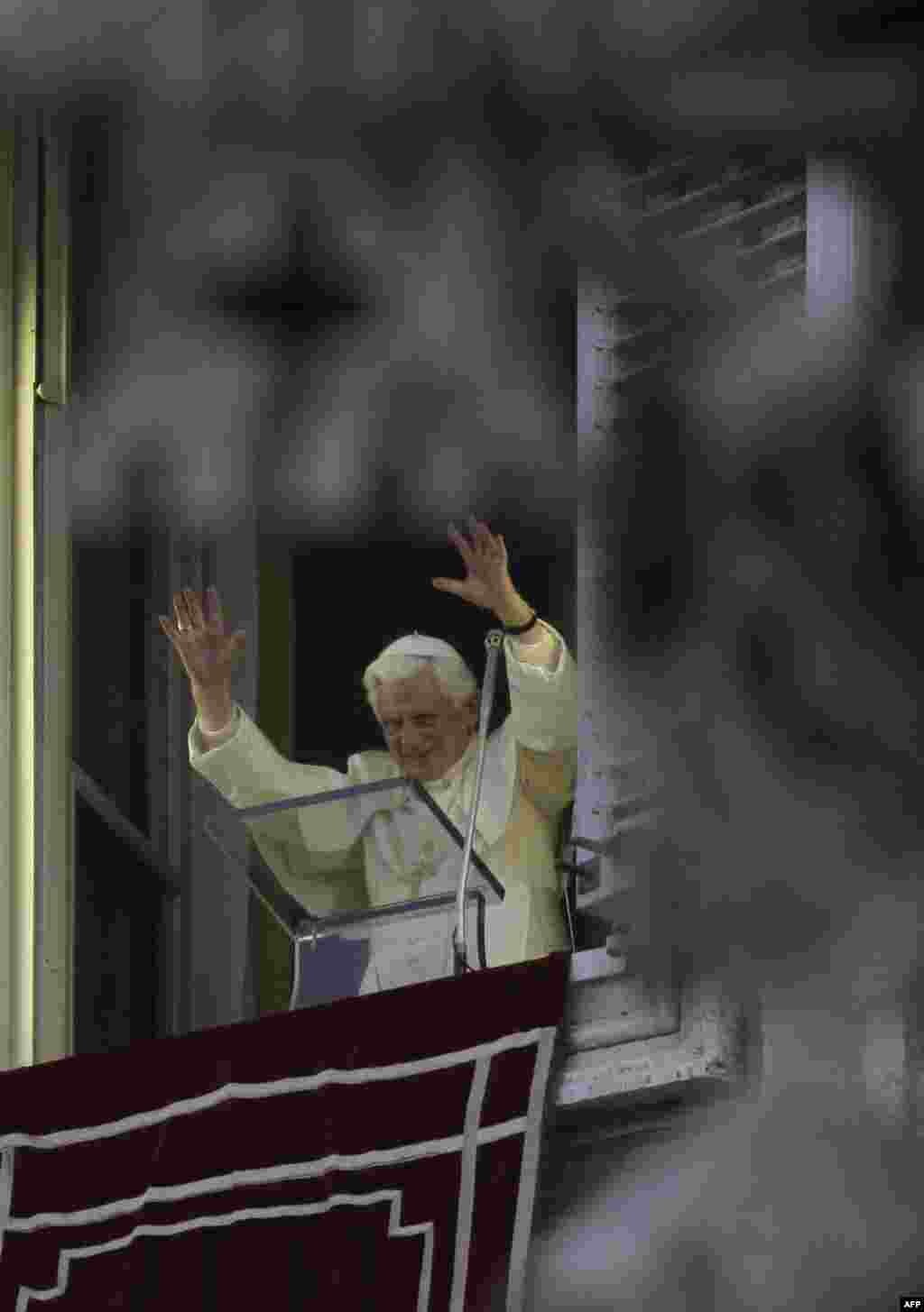 Pope Benedict XVI waves during the Angelus prayer he celebrated from the window of his studio overlooking St. Peter's square at the Vatican on the occasion of All Saints Day, Monday, Nov.1, 2010. Pope Benedict XVI denounced the "ferocious'' attack on a Ba