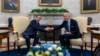 President Joe Biden, right, shakes hands with Israel's President Isaac Herzog during their meeting in the Oval Office of the White House in Washington, Nov. 12, 2024.