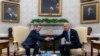 President Joe Biden, right, shakes hands with Israel's President Isaac Herzog during their meeting in the Oval Office of the White House in Washington, Nov. 12, 2024.