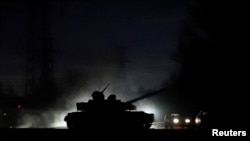 A tank drives along a street in Donetsk