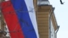 FILE - This photograph shows a Russian flag next to the U.S. embassy building in Moscow, on March 7, 2024.