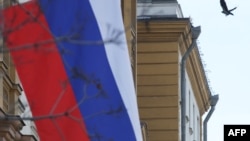 FILE - This photograph shows a Russian flag next to the U.S. embassy building in Moscow, on March 7, 2024.