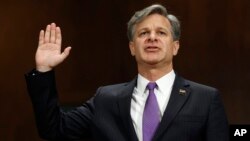 FILE - Christopher Wray is sworn in on Capitol Hill in Washington, July 12, 2017, prior to testifying at his confirmation hearing before the Senate Judiciary Committee. 