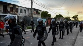 Riot police walk the streets after a demonstration against the government of President Miguel Diaz-Canel in Arroyo Naranjo Municipality, Havana, July 12, 2021.