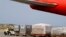 FILE - Workers unload medical supplies from a Chinese airplane at the Simon Bolivar International Airport in Maiquetia, near Caracas, Venezuela, March 29, 2019. 