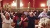 Members of "Yes We Can: Middle East Peace" dance together at a historic synagogue in downtown Washington DC