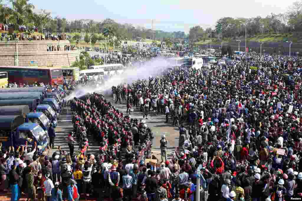 Police fire a water cannon at protesters demonstrating against the military coup and demanding the release of elected leader Aung San Suu Kyi, in Naypyitaw, Myanmar.