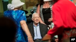 Former president Jimmy Carter, sits to pose for photos after teaching Sunday School class at Maranatha Baptist Church in his hometown of Plains, Georgia, Aug. 23, 2015.