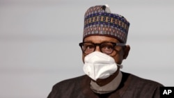 FILE - Nigeria's President Muhammadu Buhari poses before the opening session at the Summit on the Financing of African Economies, May 18, 2021, in Paris.