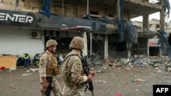 Lebanese army soldiers secure the area outside a building that was targeted in an Israeli airstrike in Beirut's southern suburbs on November 2, 2024, amid the ongoing war between Israel and Hezbollah. Lebanon's health ministry said 11 people were wounded on November 2 in an Israeli strike on Hezbollah's south Beirut stronghold, which has been hard hit by the Israel-Hezbollah war. 