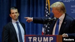 FILE - Then U.S. Republican presidential candidate Donald Trump welcomes his son Donald Trump Jr. to the stage at a campaign event in Manchester, New Hampshire November 11, 2015. 