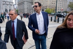 Andrey Kukushkin, center, leaves federal court Oct. 17, 2019, in New York. Kukushkin and David Correia pleaded not guilty of conspiring with associates of Rudy Giuliani to make illegal campaign contributions.
