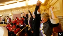 FILE - Donna Granski cheers passage of an ERA resolution in the Senate in Richmond, Virginia, Jan. 27, 2020. Democrats are trying to make Virginia the region's progressive leader, but how the state will vote on Super Tuesday is anyone's guess.