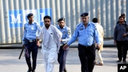 Security personnel detain supporters of imprisoned former Prime Minister Imran Khan's party Pakistan Tehreek-e-Insaf during a protest in Islamabad, Pakistan, Oct. 4, 2024.