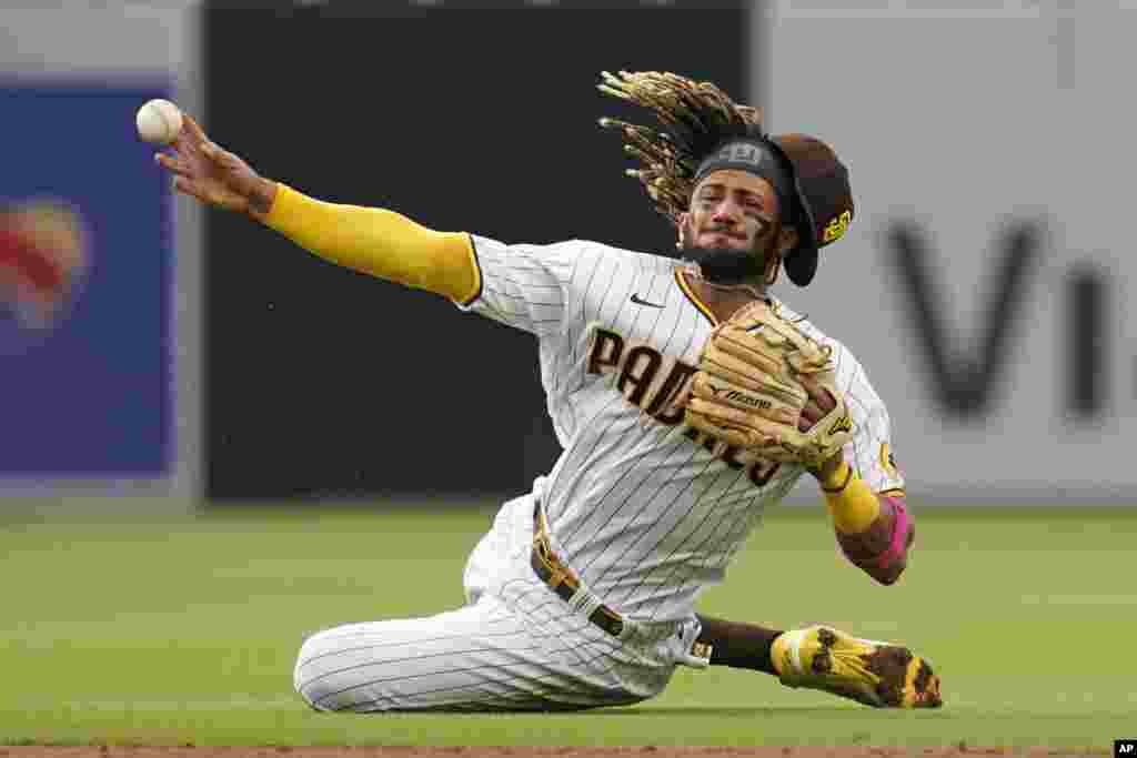 San Diego Padres shortstop Fernando Tatis Jr. throws late to first as Pittsburgh Pirates&#39; Adam Frazier arrives safely for a single during the third inning of a baseball game May 5, 2021, in San Diego, California.