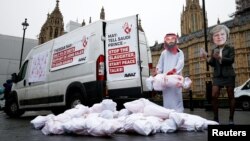 Activists from Avaaz stage a protest timed to coincide with the visit by Saudi Arabia's Crown Prince Mohammad bin Salman outside the Houses of Parliament in London, Britain, March 7, 2018. 