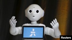 FILE - Pepper, an emotional Robot, greets conference attendees during the Wall Street Journal Digital Live (WSJDLive) conference at the Montage hotel in Laguna Beach, California October 20, 2015.