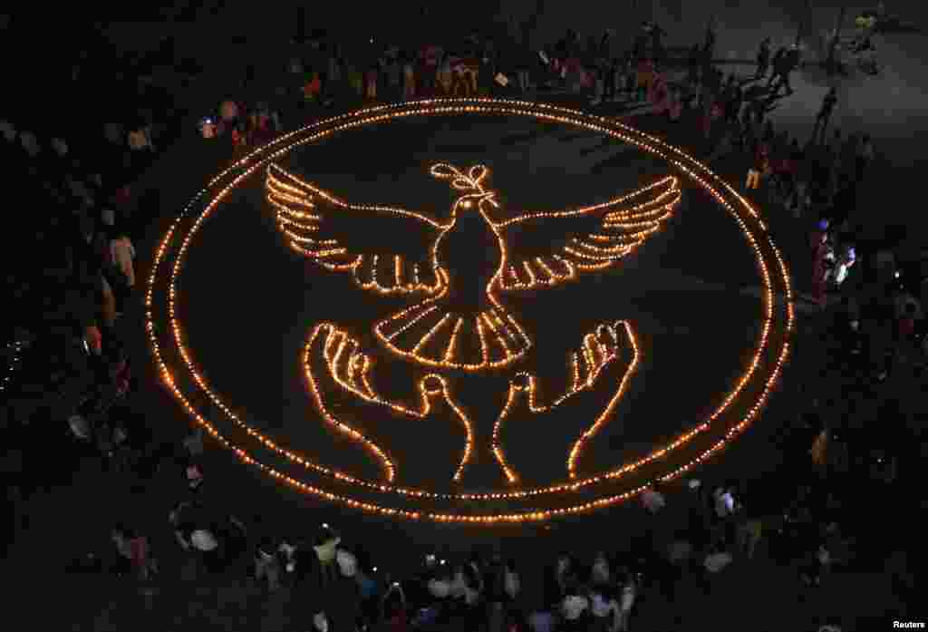 People light lamps as they make a formation of a peace symbol on the eve of Diwali, the Hindu festival of lights, in the northern Indian city of Chandigarh.