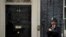 A police officer stands guard outside the door of 10 Downing Street in London, June 7, 2019. 