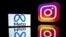 FILE - This photograph taken on Jan. 12, 2023, shows a smartphone and a computer screen displaying the reflected logos of Instagram app and its parent company Meta in Toulouse, south-western France.