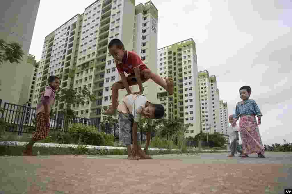 Children play near an apartment complex on the outskirts of Yangon, Myanmar.