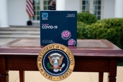 A 5-minute test kit for COVID-19 developed by Abbott Laboratories sits on a table ahead of a briefing by President Donald Trump about the coronavirus in the Rose Garden of the White House, March 30, 2020, in Washington.