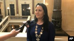 FILE - Shannon Holsey, president of the Stockbridge-Munsee tribe, speaks to reportersin the Wisconsin state Capitol April 4, 2017. Indigenous students from Wisconsin will be able to attend the University of Wisconsin-Madison for free beginning next fall. 