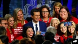 Democratic presidential candidate South Bend Mayor Pete Buttigieg poses with an advocacy group after the Democratic primary debate hosted by NBC News at the Adrienne Arsht Center for the Performing Art, June 27, 2019, in Miami, FL. 