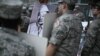 Members of the Civil Air Patrol hold photographs of veterans during the National Memorial Day parade held by the American Veterans Center in Washington, DC, on Memorial Day, May 27, 2024.