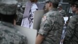 Members of the Civil Air Patrol hold photographs of veterans during the National Memorial Day parade held by the American Veterans Center in Washington, DC, on Memorial Day, May 27, 2024.