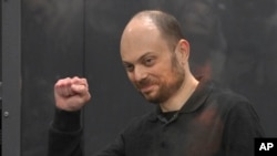 FILE - Russian opposition activist Vladimir Kara-Murza gestures while standing in a defendant's cage at Moscow City Court in Moscow, July 31, 2023.