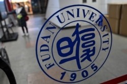 In this picture taken on Dec. 18, 2019, a Fudan University sign is seen on the campus in Shanghai.