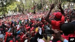 Opposition supporters march on the streets of Harare, Zimbabwe, Tuesday, June, 5, 2018. The party supporters were demanding electoral reforms ahead of a July 30 vote, the first since Robert Mugabe stepped down last year.