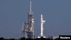 A SpaceX Falcon 9 rocket sits at the Kennedy Space Center at Cape Canaveral, Fla., after a the launch of a resupply mission to the International Space Station was scrubbed because of a technical problem, Feb. 18, 2017.