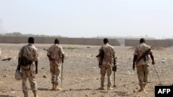 FILE - Sudanese troops with a military coalition in Yemen backed by Saudi Arabia and the United Arab Emirates detect mines at a facility in the Yemeni port city of Hodeidah, Jan. 22, 2019.