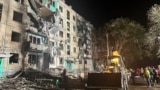 FILE - In this photo released by Ukraine's National Police, onlookers gather after a Russian strike on a residential building in Kharkiv, Ukraine, Oct. 2, 2024. A U.N. report issued on Jan. 8, 2025, accuses Russia of carrying out a policy of mass destruction against Ukraine.