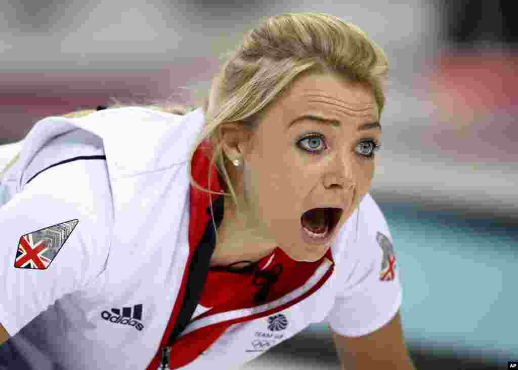 Britain's Anna Sloan shouts after delivering the stone during women's curling competition against Russia at the 2014 Winter Olympics, Feb. 17, 2014.