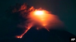 Lava cascades down the slopes of Mayon volcano as seen from Legazpi city, Albay province, around 340 kilometers (210 miles) southeast of Manila, Philippines, Jan. 15, 2018. 