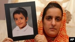 In Oldham, Manchester, northwest England, Akila Naqqash, holds a picture of her five-year-old son, Sahil Saeed, who was kidnapped while visiting his grandmother in Jhelum, Pakistan, 4 Mar 2010
