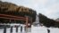 A man walks next to a closed chairlift at Les Portes du Soleil ski resort during the global outbreak of the coronavirus disease (COVID-19), in Chatel, France, Dec. 19, 2020. 