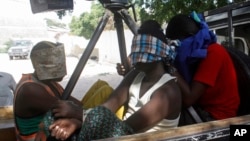 FILE - Suspected Al-Shabab militants captured during an attack on an African Union base are seen in Mogadishu, Somalia, Dec. 25, 2014.